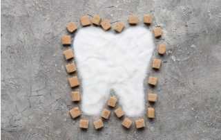 sugar and candy in the shape of a tooth representing Type 2 Diabetes and Oral Health