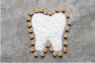 sugar and candy in the shape of a tooth representing Type 2 Diabetes and Oral Health